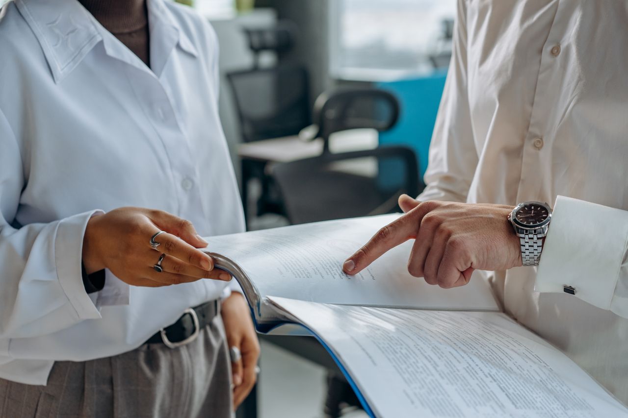 Two professionals reviewing case documents together